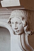 Carved head on stone fireplace in Sussex home UK