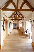 Wooden hallway with beamed pitch ceiling in Sussex home UK