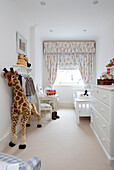 Toy giraffe in childs bedroom in contemporary London townhouse, England, UK