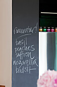 Handwritten shopping list on blackboard in contemporary London home, UK