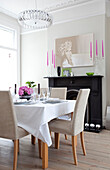 Modern art canvas above dining table in contemporary London home, UK