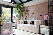 Pink fittings and wall decor in conservatory in contemporary London townhouse, England, UK