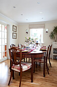 Antique wooden dining table in Kent cottage, England, UK