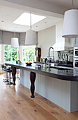 Oversized lampshades in kitchen of classic London home, UK