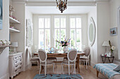 Decorative white painted mirrors in dining alcove of contemporary London home, UK