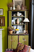 Salvaged display cabinet with ornaments in living room of London home England UK