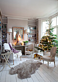 Christmas tree in bay window of London home with effigy on table, England, UK