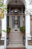 Porch exterior of London townhouse at Christmas, England, UK