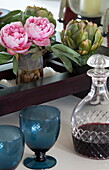 Pink camellia with blue wine goblets and decanter in London townhouse, England, UK