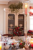 Holly and mistletoe, Christmas decoration in dining room of Surrey farmhouse, England, UK
