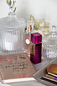 Perfume bottles and glassware with diary in London apartment, UK