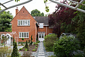 Stepping stone path and brick exterior of Dulwich home, London, England, UK