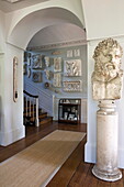 Historic staute and plaster-casts in entrance hallway of Sussex home England UK
