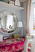 Convex mirror above dressing table in Sussex home England UK