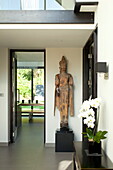 Buddha statue in hallway of contemporary new build, Kingston upon Thames, England, UK