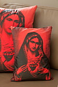 Virgin Mary cushions on leather armchair in contemporary home, Kingston upon Thames, England, UK