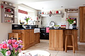 Wood fitted kitchen with wall mounted shelf in Staffordshire farmhouse kitchen England UK