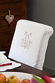 Art deco motif on white slip cover of dining chair in Staffordshire farmhouse England UK