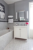 Washstand and photographic print in bathroom of London townhouse England UK