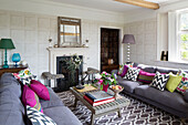 Assorted scatter cushions with patterned rug in Herefordshire living room England UK