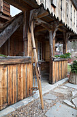 Vintage skis at porch entrance to mountain chalet in Chateau-d'Oex, Vaud, Switzerland