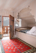 Alcove bed at open door of mountain chalet in Chateau-d'Oex, Vaud, Switzerland