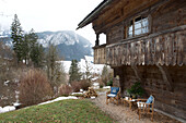 Folding chairs under balcony exterior of mountain chalet in Chateau-d'Oex, Vaud, Switzerland