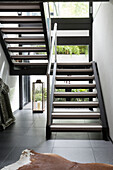 Ponyskin-Teppich mit offener Treppe in einem modernen Haus im Südwesten Londons, England, Vereinigtes Königreich