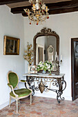 Green upholstered armchair with mirror and console in French farmhouse in the Loire, France, Europe