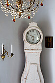 Grandfather clock with candle holder and cut glass chandelier in French farmhouse in the Loire, France, Europe