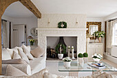 White sofa with glass topped coffee table in white living room of West Mailing home, Kent, England, UK
