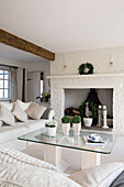 Glass-topped coffee table in whitewashed living room of West Mailing home, Kent, England, UK