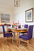 Purple dining chairs in laminate dining room of West Sussex home, England, UK