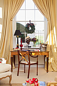 Desk and chair at window with champagne bucket in West Sussex home, England, UK