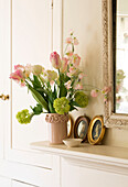 Cut flowers and cameos on mantlepiece in London home England UK
