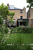 Back garden and brick exterior of Oxfordshire home England UK