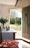 View through sunlit Camber doorway from hallway to garden East Sussex England UK