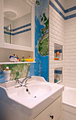 Wall map an bath toys in tiled bathroom of London townhouse, England, UK