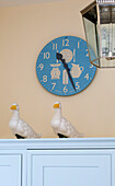 Blur clock face and ornamental ducks on sideboard in London townhouse, England, UK