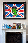 Satirical Union Jack artwork above fireplace in London townhouse, England, UK