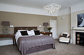 Double bed with matching lamps and honesty lampshade in contemporary Sussex home, England, UK