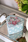 Light blue heart shaped tin on silver tray in UK home