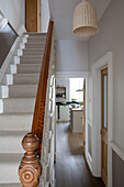Wooden banister on carpeted staircase in hallway of Shoreham by Sea home   West Susses   England   UK