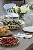 Pies and salad with cut rose on dining table in Shoreham by Sea home   West Susses   England   UK