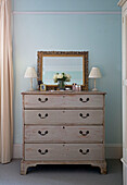 Pair of lamps in chest of drawers with mirror in light blue Shoreham by Sea bedroom   West Susses   England   UK