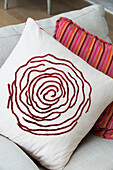 Rose and striped patterns on cushions in UK home