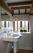 Wash basin and sink in white panelled bathroom of Suffolk farmhouse,  England,  UK