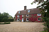 Gravel driveway in front of brick detached London home,  Autumn,  England,  UK