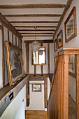 Framed artwork and wooden banisters in timber framed London home,  England,  UK