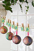 Christmas baubles hang with pegs in Berkshire home,  England,  UK